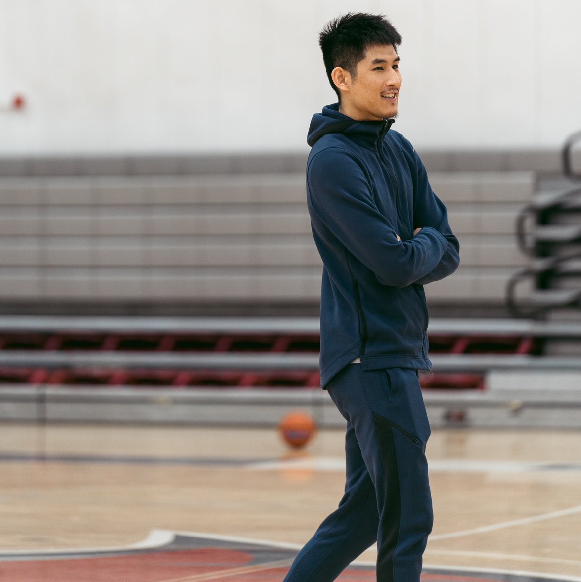 Coach watching practice with arms crossed