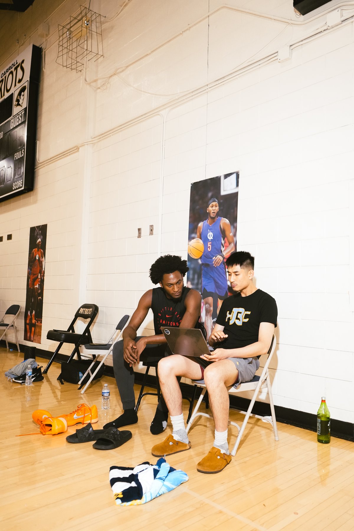 Athletes reviewing game film on a laptop